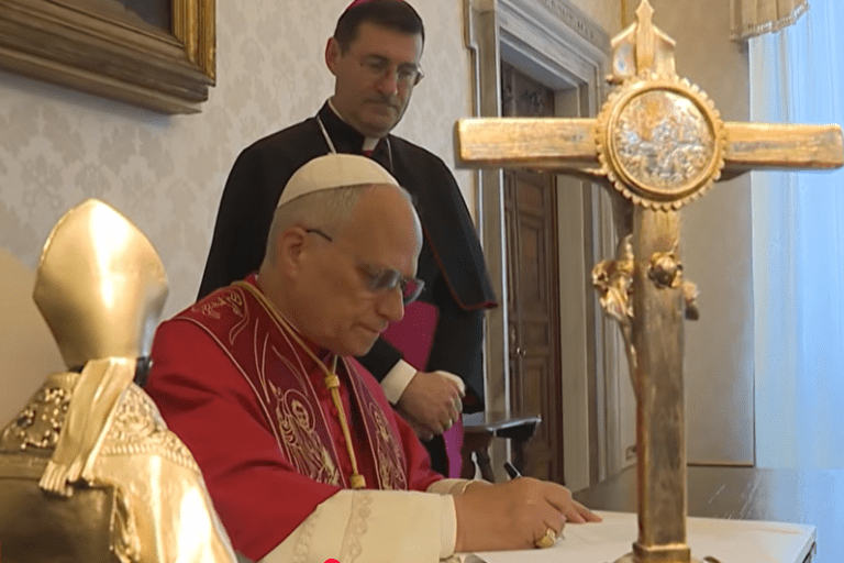 Pope Leo signing the Encyclical Letter